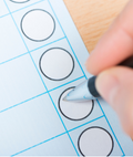 Person filling out a blank ballot.
